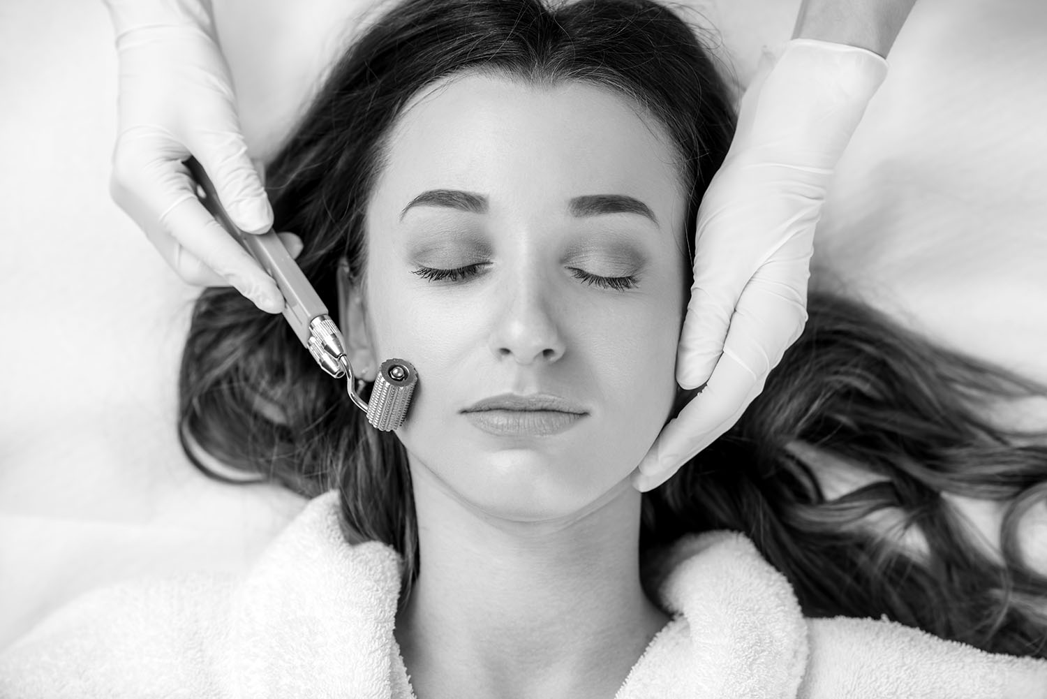 Making dry needlying procedure on woman's face in the cosmetology office